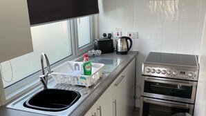 A compact kitchen with a sink, a toaster, a kettle, and a double oven. - Chalet 91A South Shore Bridlington (Bridlington)