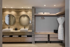 A modern bathroom with two sinks, a large mirror, and a robe rack. - Atlantica Sancta Napa Resort (Ayia Napa)