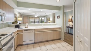 A kitchen with a large island, white appliances, and a view to the dining area. - Walk-In w/2 King Bd/ 2 Ba Golf Course/ Deals on Golf/Tickets! (Branson)