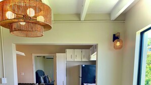 A modern interior with a kitchen, dining area, and a view of the outdoors. -  2-bedroom-ocean & St Croix views-5 minutes to Cruz Bay (Cruz Bay)