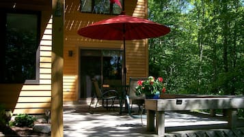 Guests can enjoy an outdoor space with a table, chairs, and a shaded area.