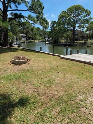 Enjoy a peaceful lakeside retreat with a dock and a cozy fire pit area.