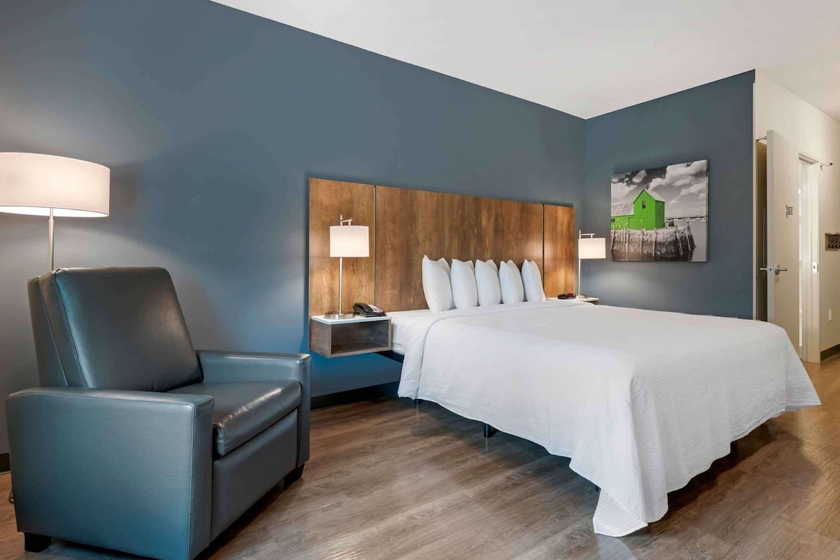 Premium bedding, desk, laptop workspace, iron/ironing board