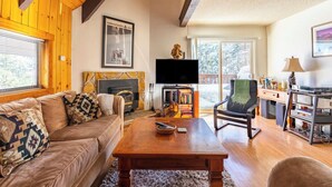 A cozy living room with a fireplace, a television, and a comfortable seating area.