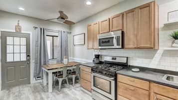 Fridge, microwave, coffee/tea maker, cookware/dishes/utensils