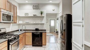 Fridge, microwave, coffee/tea maker, cookware/dishes/utensils