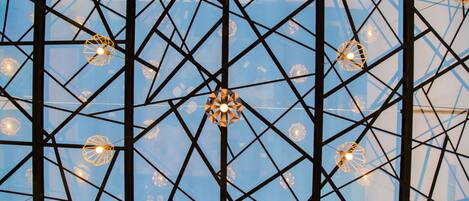 A geometric ceiling structure with multiple hanging light fixtures.