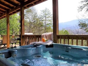 A hot tub with a wooden deck and a view of trees and mountains. - Beautiful Mountain Cabin with EV Charging Outlet! Enjoy Spring and Summer Here! (Gatlinburg)