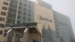 A multi-story building with a prominent 'Savcr' sign on the facade. - Silver Creek 1104  Studio Sleeps 3,  Slope Side (Snowshoe)