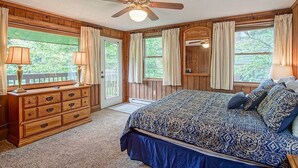 Ein Schlafzimmer mit einem Bett, einem Schminktisch und einem Deckenventilator.