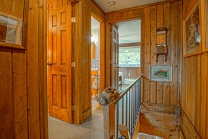 Staircase leads to a cozy dining or living area with a table and chairs.