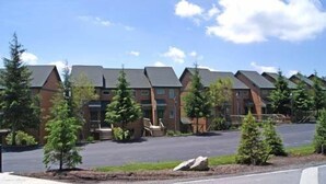 A row of brick buildings with sloped roofs, arranged in a linear fashion.
