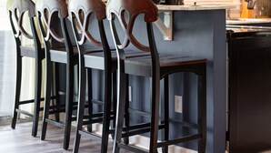 A kitchen with dark cabinetry, a central island, and a set of four chairs with ornate backs. - country home minutes from downtown Asheville (Asheville)