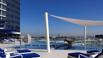 Outdoor pool, pool loungers, lifeguards on site