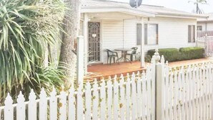 A single-story house with a covered porch, a satellite dish, and a white picket fence. - Rye Sleeps 10, Great Weekender (Rye)