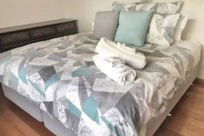 Restful retreat with a geometric-patterned bedspread and a clean, simple design.