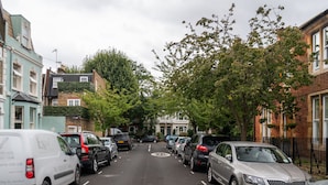 A street lined with parked cars and buildings. - Traditional Fulham Home Close to the River Thames by Underthedoormat (London)