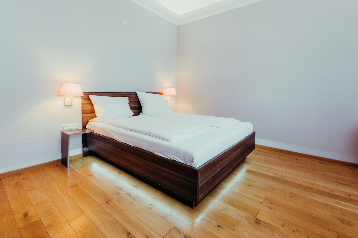 Hypo-allergenic bedding, desk, laptop workspace, blackout drapes