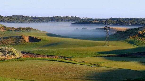 A golf course with a windmill, rolling hills, and a misty lake in the background. - Secret Dream Location with WIFI and Wine (Rye)