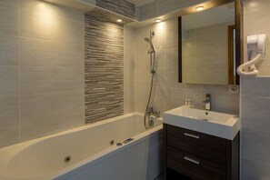 Bathtub, towels, toilet paper