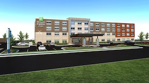 Un bâtiment Holiday Inn Express & Suites doté d’un parking et d’une entrée abritée.