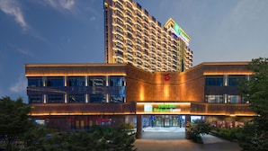 A Holiday Inn Express hotel with a modern design, featuring a prominent entrance and a large sign. - Holiday Inn Express Nanchang Bayi Square by IHG (Nanchang)