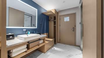 A modern bathroom with a dual sink vanity, a large mirror, and a towel rack.