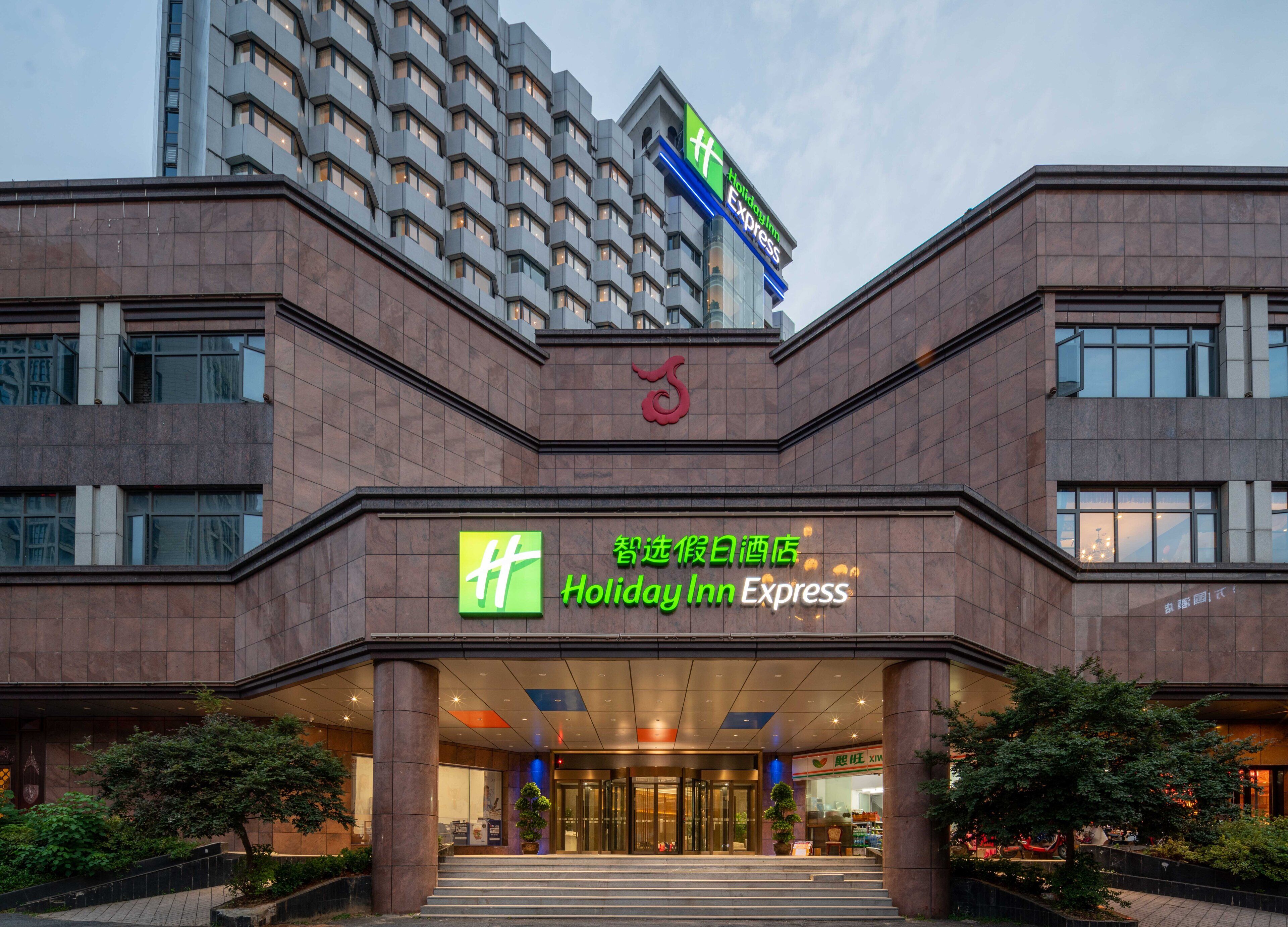 A Holiday Inn Express building with a modern design, featuring a prominent entrance and signage.