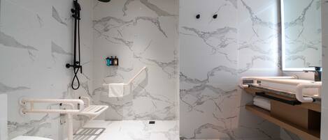 A modern bathroom with a shower, toilet, and vanity.