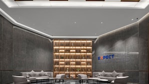 A modern lobby with a seating area, a wall-mounted display, and a ceiling with recessed lighting. - Holiday Inn Express Nanchang Bayi Square by IHG (Nanchang)