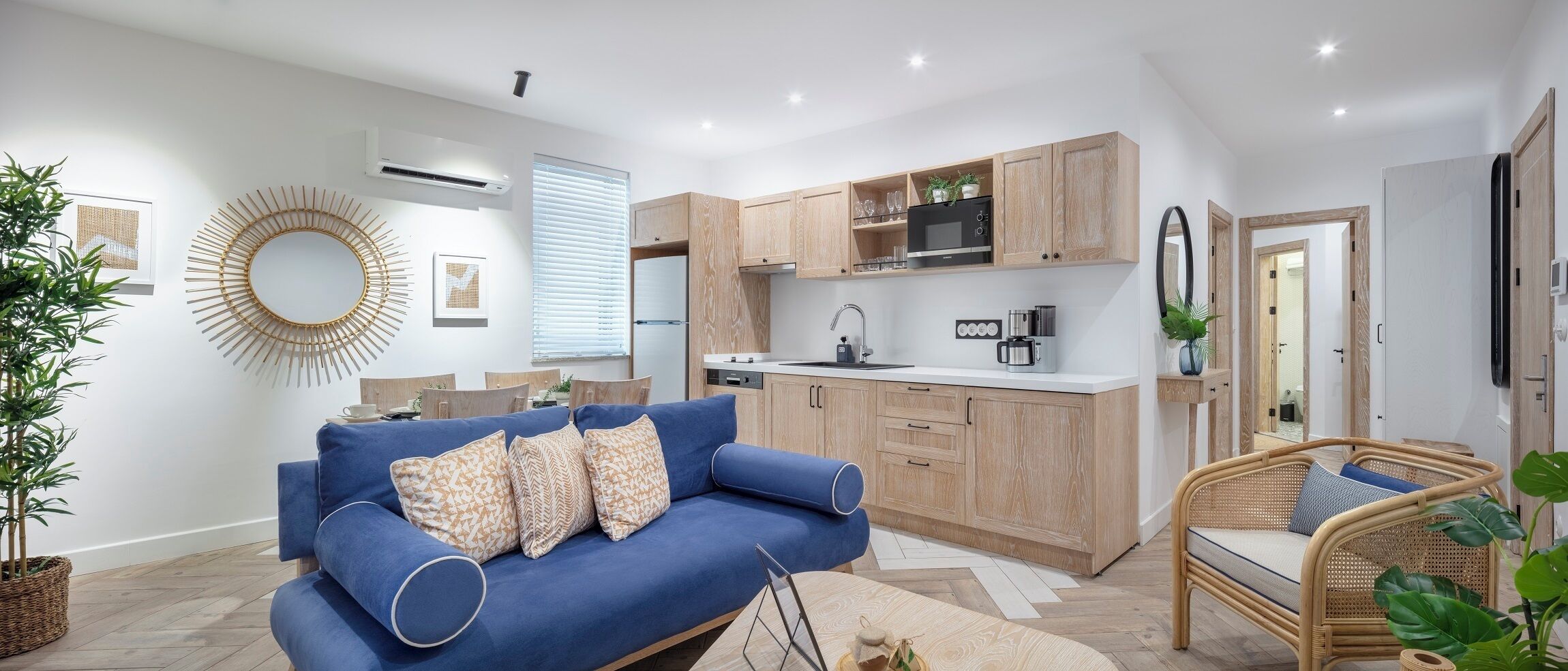 A modern kitchen with wooden cabinets, a built-in microwave, and a sink.