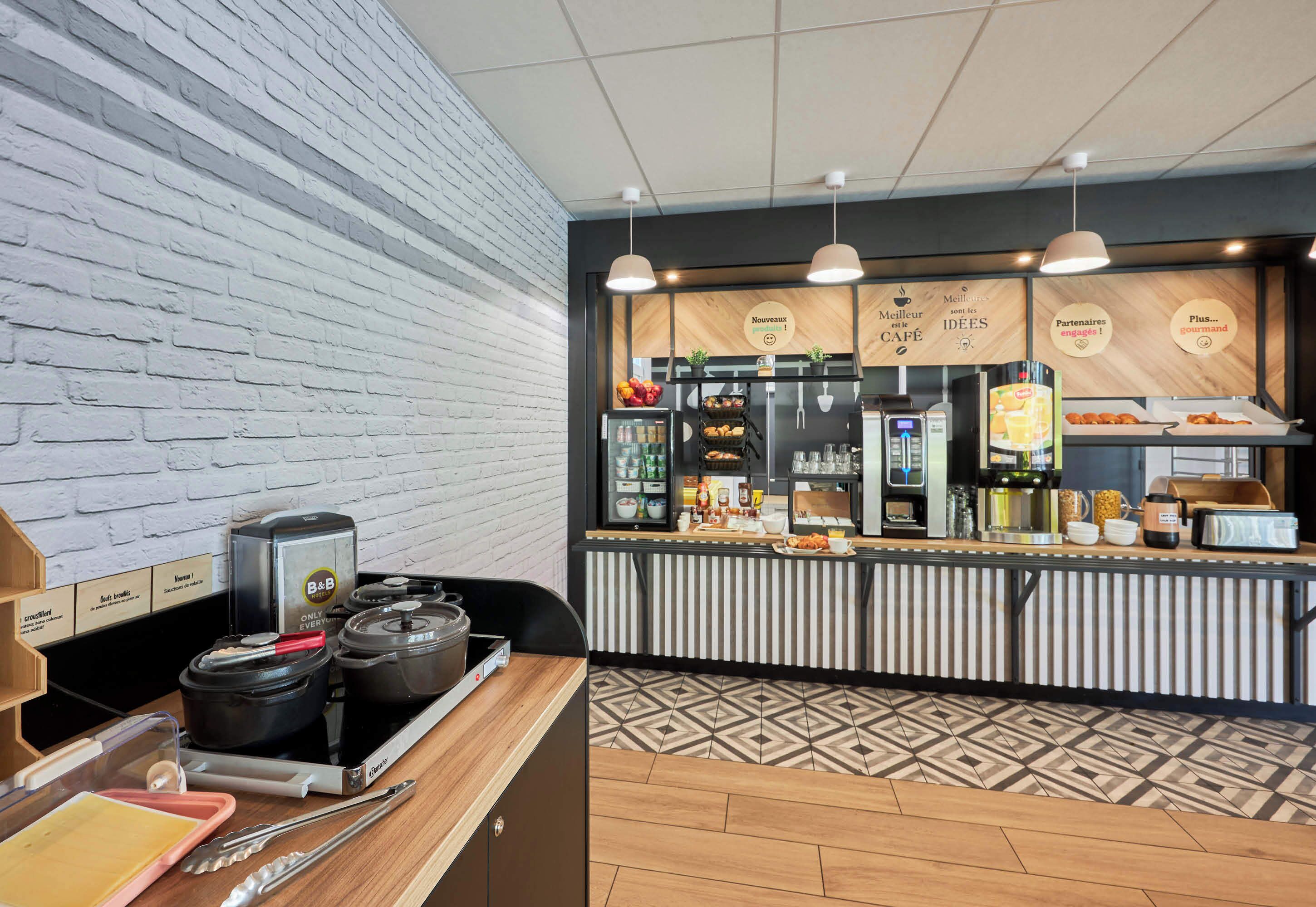 A kitchen area with a brick wall, a counter with various food items, and a stove.