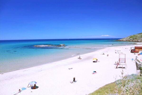 Enjoy a serene beach experience with calm waters and a wide sandy shore.