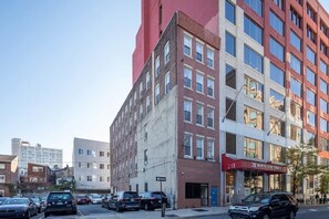 Urban building with a mix of architectural styles, featuring brick and concrete facades and large windows.
