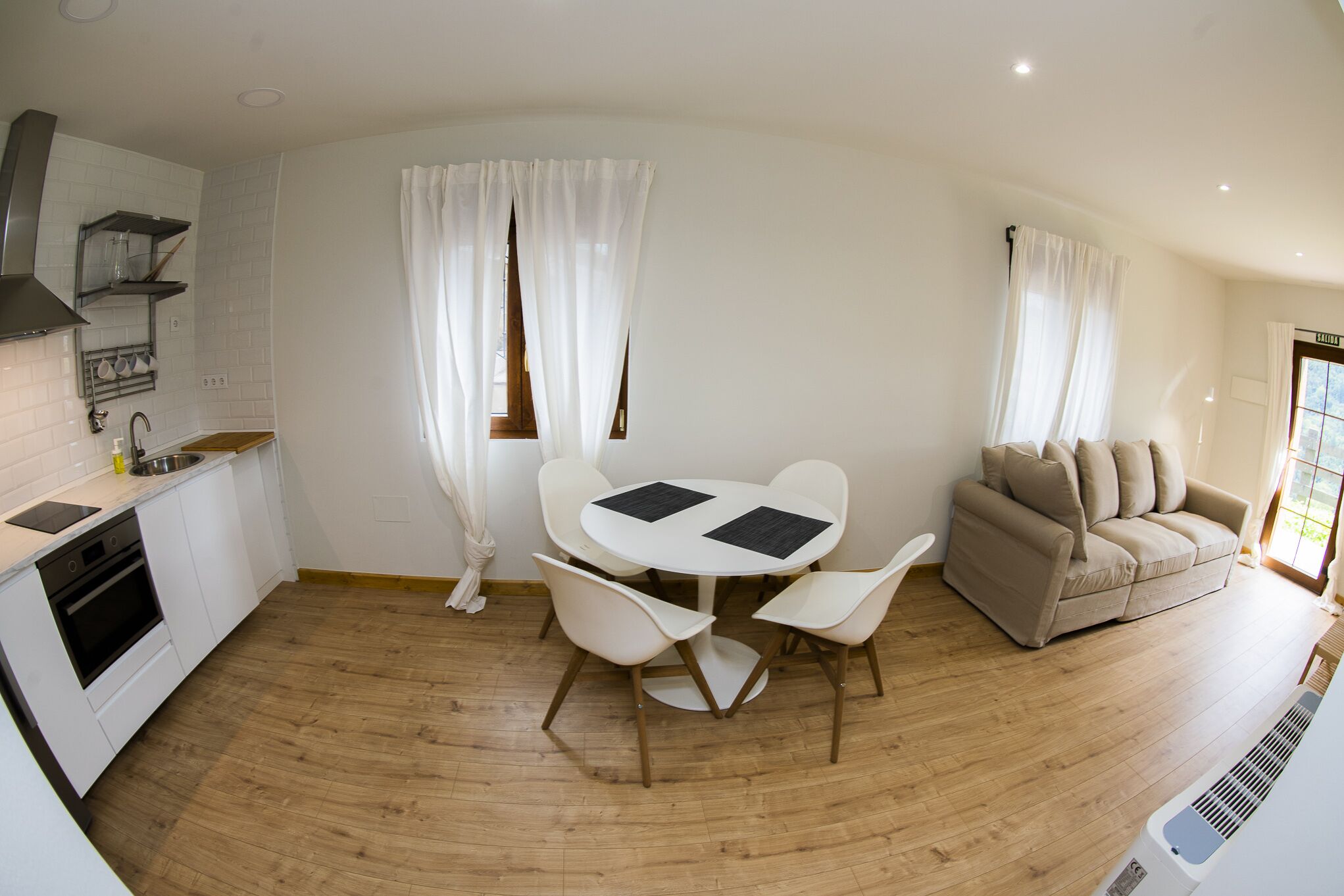 A compact living space with a kitchen, dining area, and seating area.