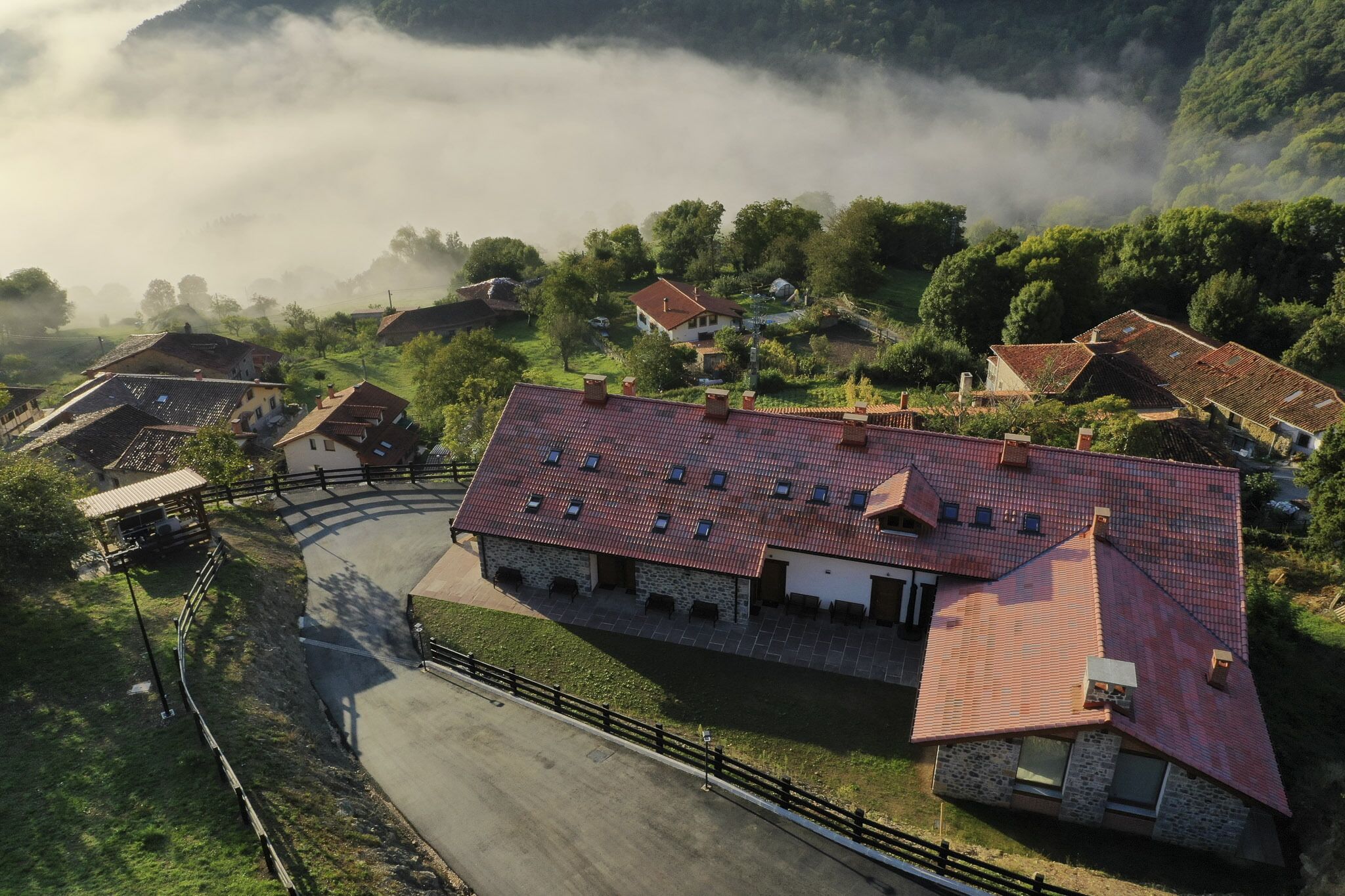 A rural village with stone buildings and a paved road.