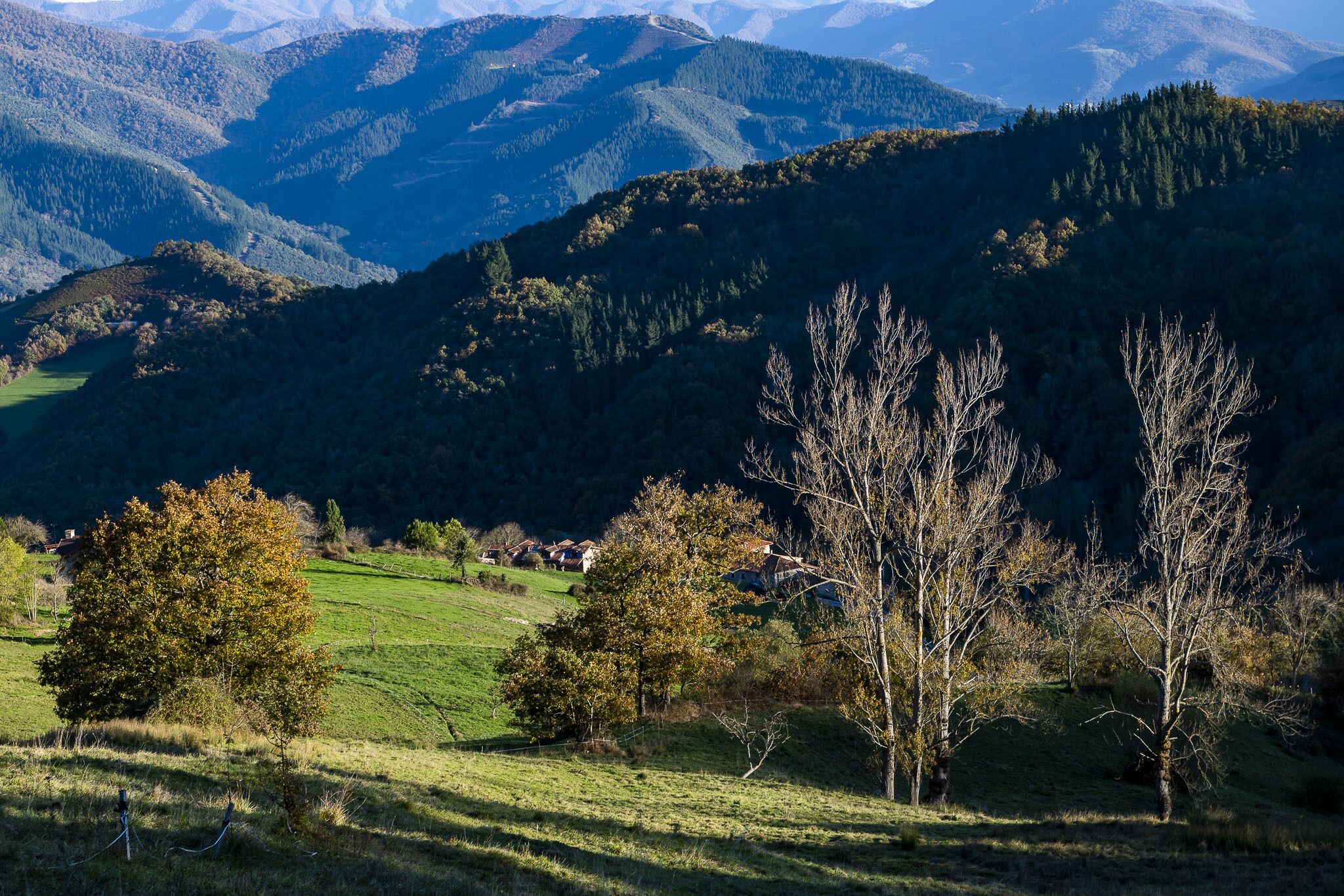 A mountainous landscape with a small village nestled in the valley.