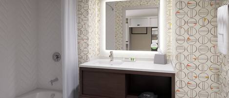 Une salle de bain avec une douche, un lavabo avec un miroir et un porte-serviettes.