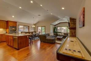 Enjoy a spacious interior with a large kitchen, dining area, and comfortable living space featuring a pool table.