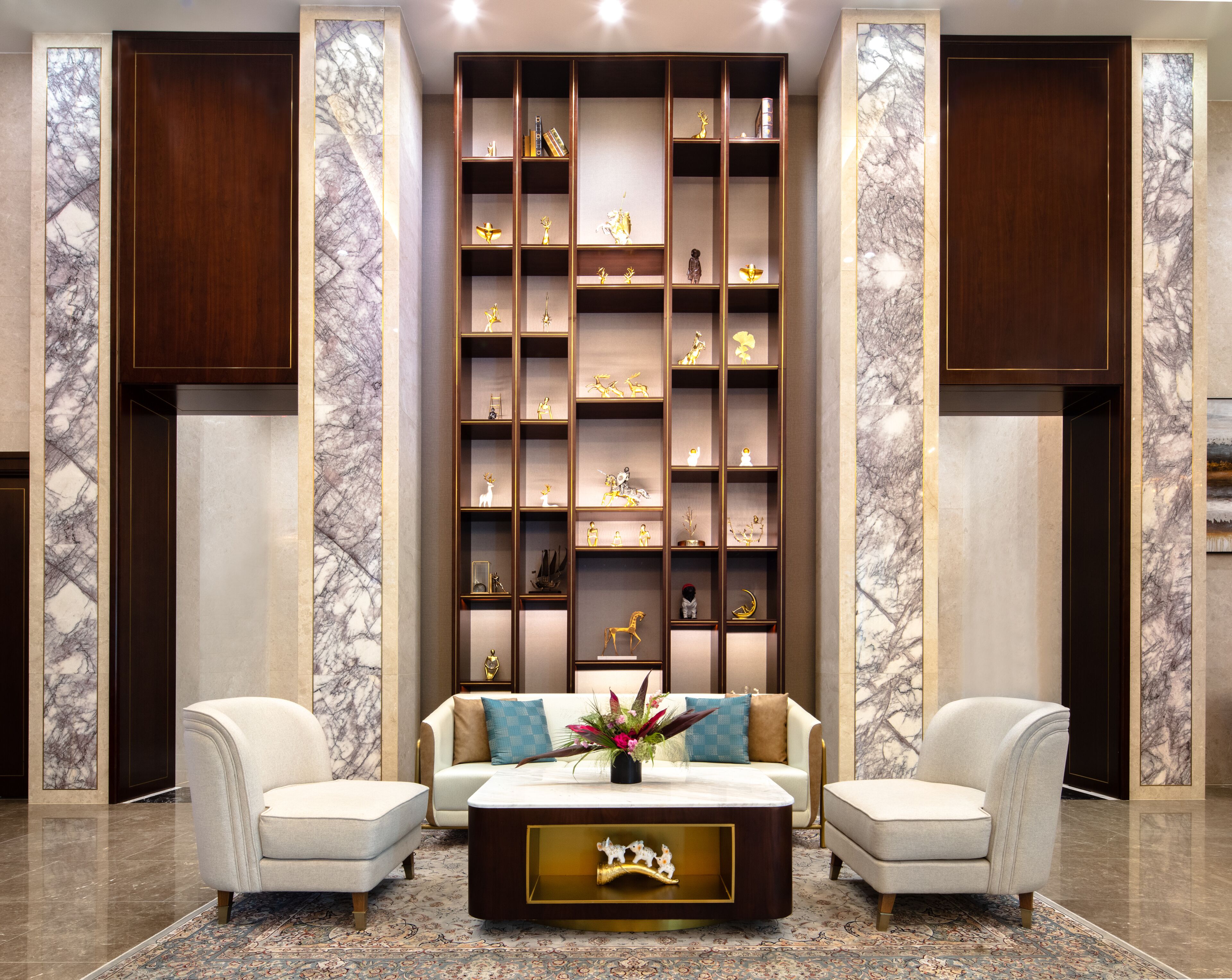 A modern living room with a sofa set, a coffee table, and a decorative bookshelf.