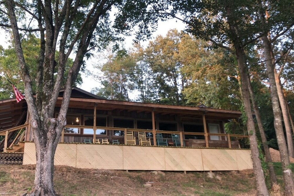 Cabin with 40 ft porch overlooking a pond.