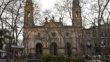 Un edificio histórico con dos torres destacadas, ventanas en arco y una entrada central.