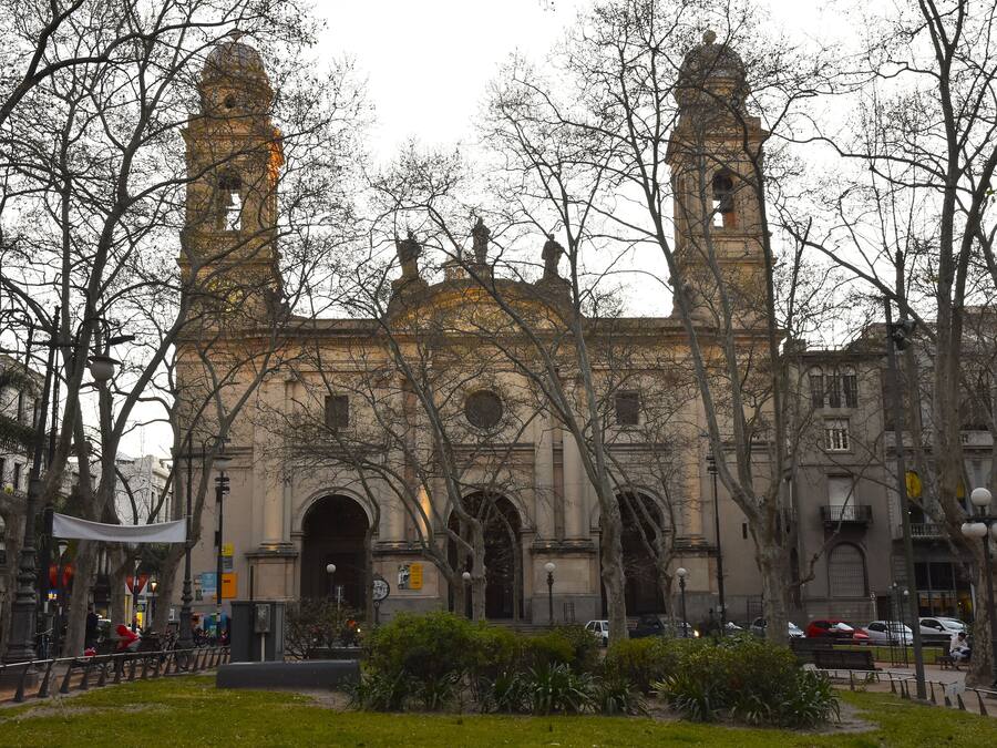 A historic building with two prominent towers, arched windows, and a central entrance.