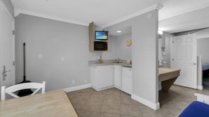Kitchen area with microwave, sink, and dining space.