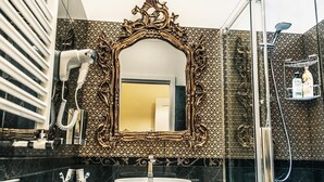 A bathroom with a large ornate mirror, a white sink, and a shower area. - Executive Suite room (Roma)