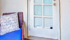 A white door with a frosted glass panel, a number '301' above the door, and a small wall-mounted light fixture to the right. - Studio 301 Little Paris 1 blk to the beach 1floor (Fort Lauderdale)