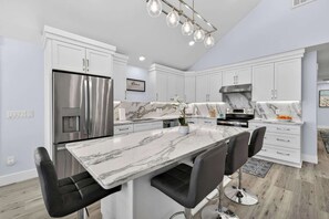 Fridge, microwave, oven, stovetop - Sea Monster by Carolina Getaway - 6BR Remodeled Oceanfront Home w/ Heated Pool (Kure Beach)