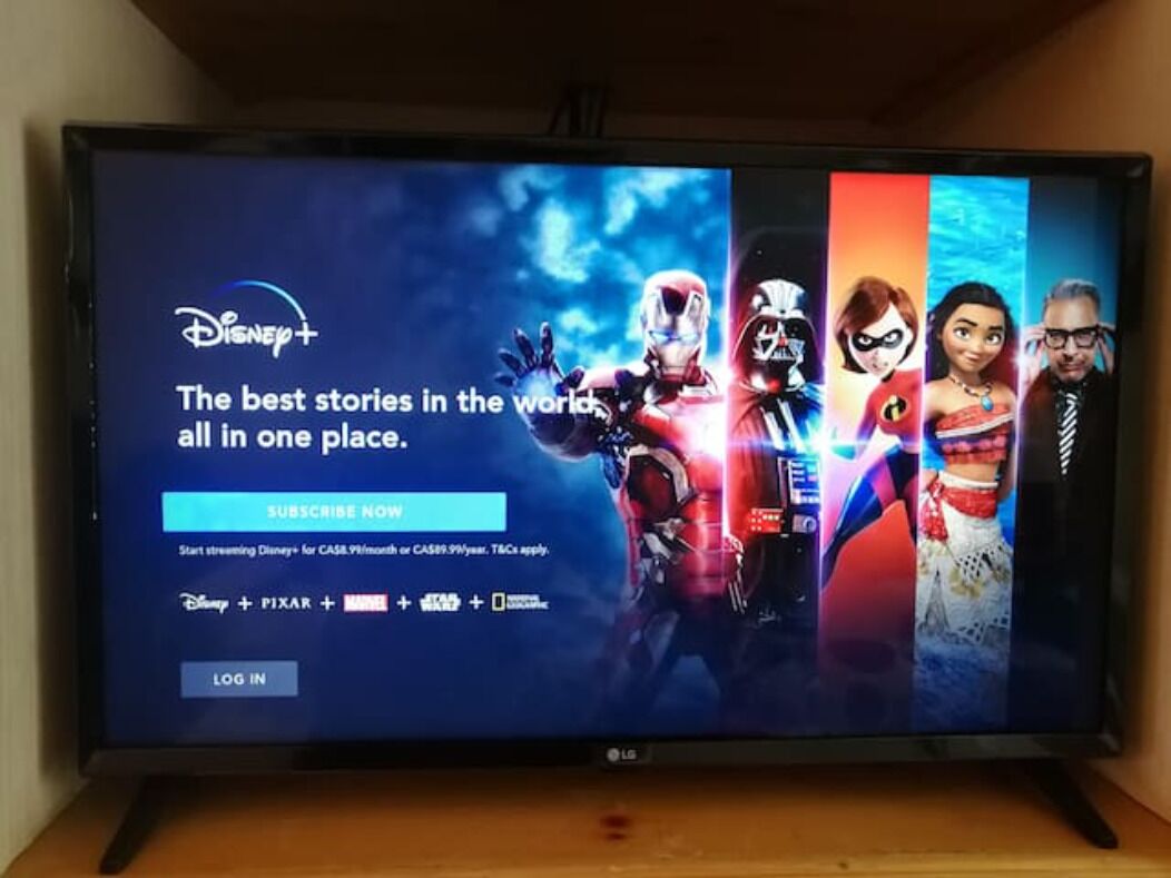 A television screen displaying a Disney+ subscription interface with characters from various franchises.