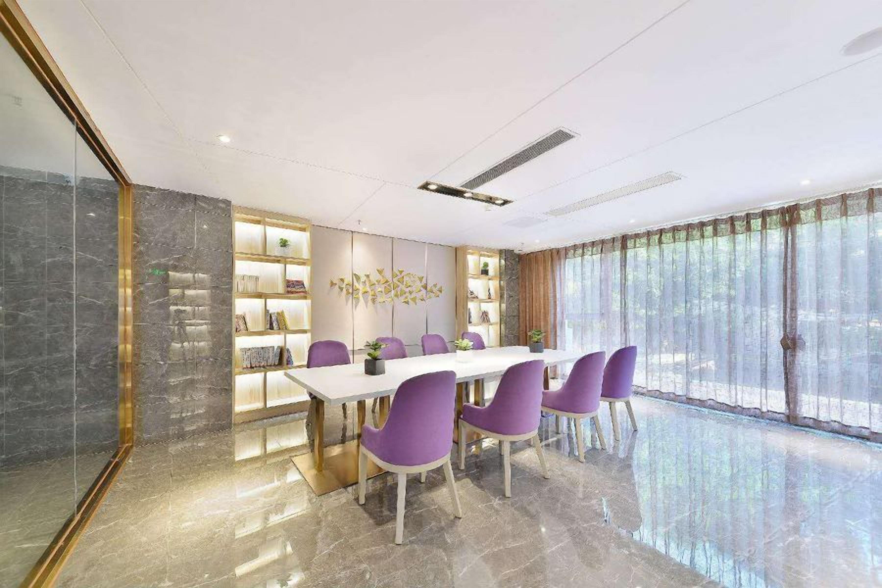 A modern dining area with a marble floor, a white table, and purple chairs.