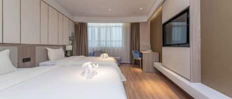 A hotel room with a large bed, a desk, a chair, a TV, and a window.